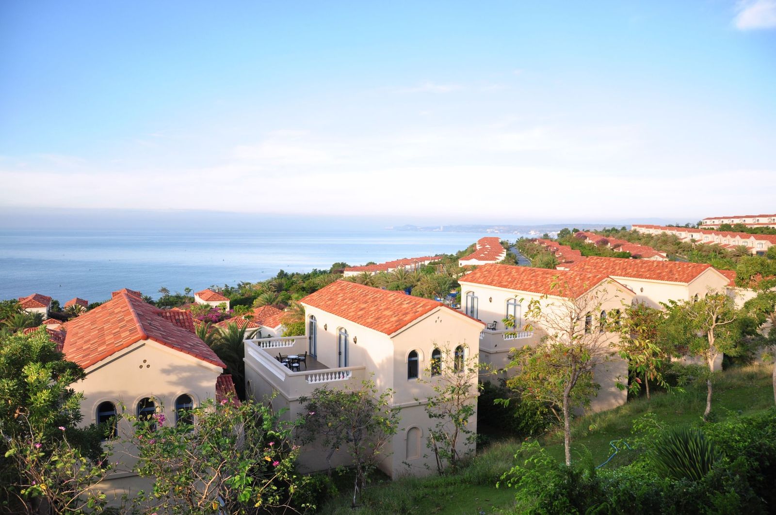 Terracotta-roofed homes on a hillside above the water